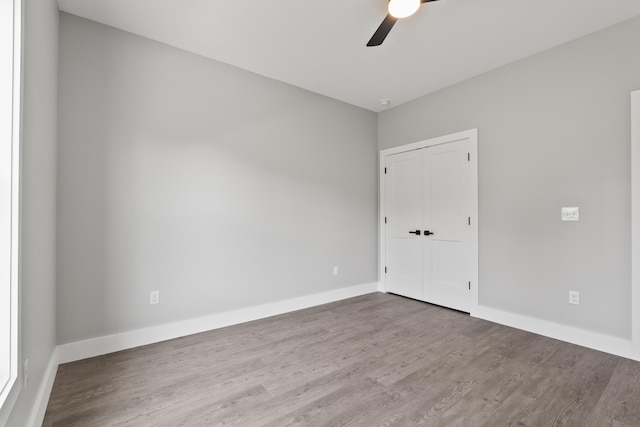 202 Max Cavnes Rd, Danville, KY 40422 - unfurnished bedroom with wood finished floors, a closet, and a ceiling fan