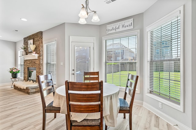 110 Kinglet Pt, Nicholasville, KY 40356 - dining room featuring baseboards, light wood-style flooring, a chandelier, a fireplace, and recessed lighting