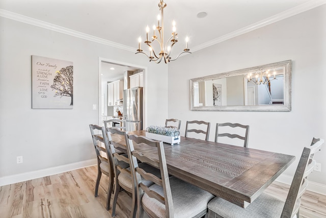110 Kinglet Pt, Nicholasville, KY 40356 - dining area featuring a chandelier, light wood finished floors, crown molding, and baseboards