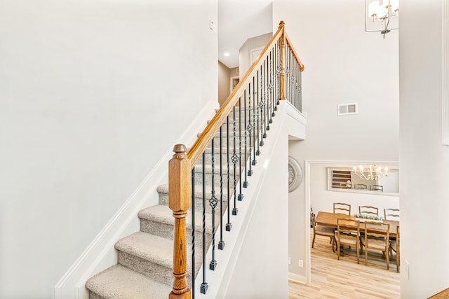 110 Kinglet Pt, Nicholasville, KY 40356 - stairway featuring a chandelier, a high ceiling, wood finished floors, and baseboards