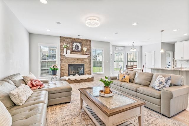110 Kinglet Pt, Nicholasville, KY 40356 - living area featuring light wood-style flooring, plenty of natural light, recessed lighting, and a stone fireplace