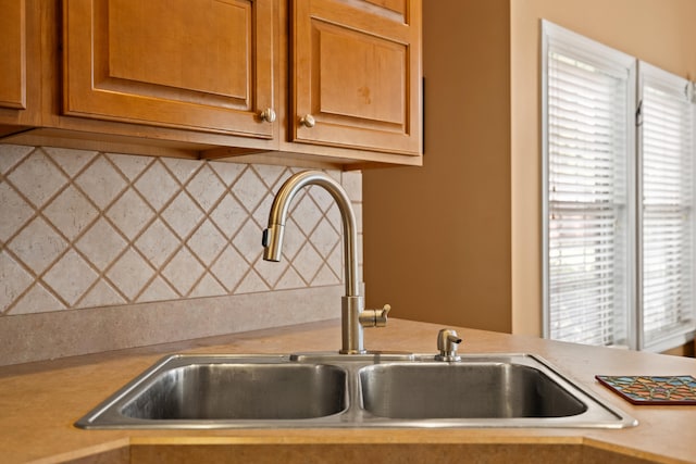 988 Fiddler Creek Way, Lexington, KY 40515 - kitchen featuring a sink, light countertops, decorative backsplash, and brown cabinetry