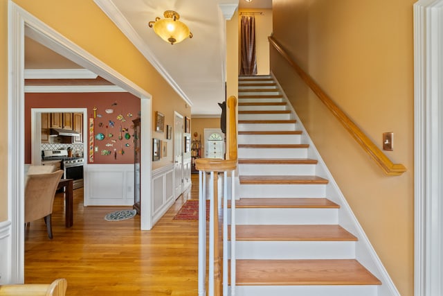 988 Fiddler Creek Way, Lexington, KY 40515 - stairs with ornamental molding, wood finished floors, and a wainscoted wall