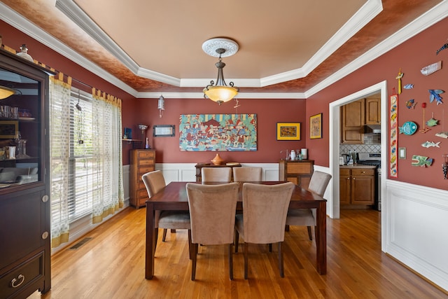 988 Fiddler Creek Way, Lexington, KY 40515 - dining room featuring a raised ceiling, light wood-style floors, crown molding, and a wainscoted wall