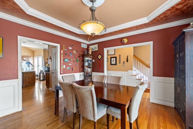 988 Fiddler Creek Way, Lexington, KY 40515 - dining room featuring wainscoting, ornamental molding, light wood finished floors, stairs, and a raised ceiling