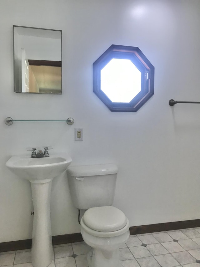 5713 Bybee Rd, Ashland, KY 41102 - bathroom featuring toilet, baseboards, a sink, and tile patterned floors