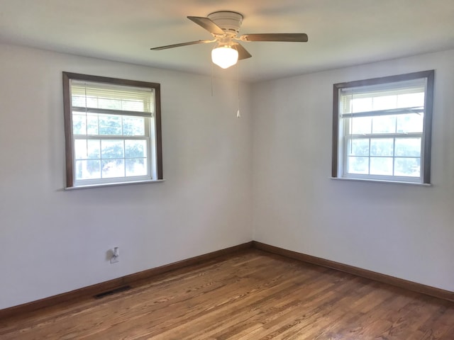 5713 Bybee Rd, Ashland, KY 41102 - unfurnished room featuring plenty of natural light, baseboards, wood finished floors, and a ceiling fan