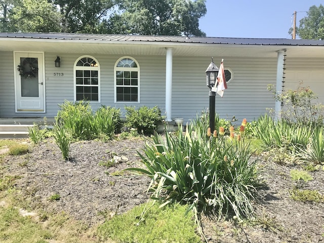 5713 Bybee Rd, Ashland, KY 41102 - view of front of property featuring covered porch, metal roof, and an attached garage