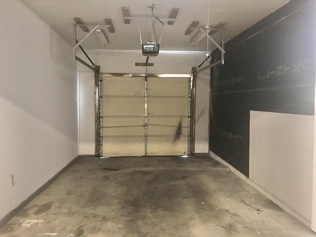 5713 Bybee Rd, Ashland, KY 41102 - garage featuring baseboards and a garage door opener