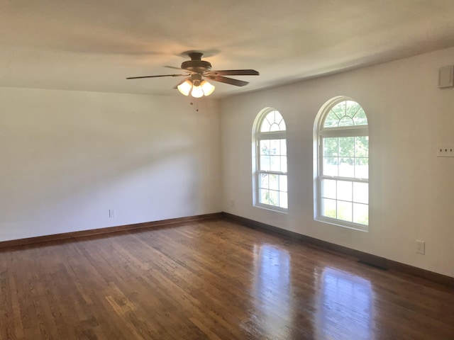 5713 Bybee Rd, Ashland, KY 41102 - empty room with dark wood finished floors, a ceiling fan, and baseboards