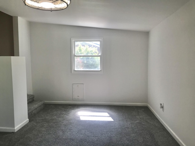5713 Bybee Rd, Ashland, KY 41102 - unfurnished room with dark colored carpet, baseboards, and stairs