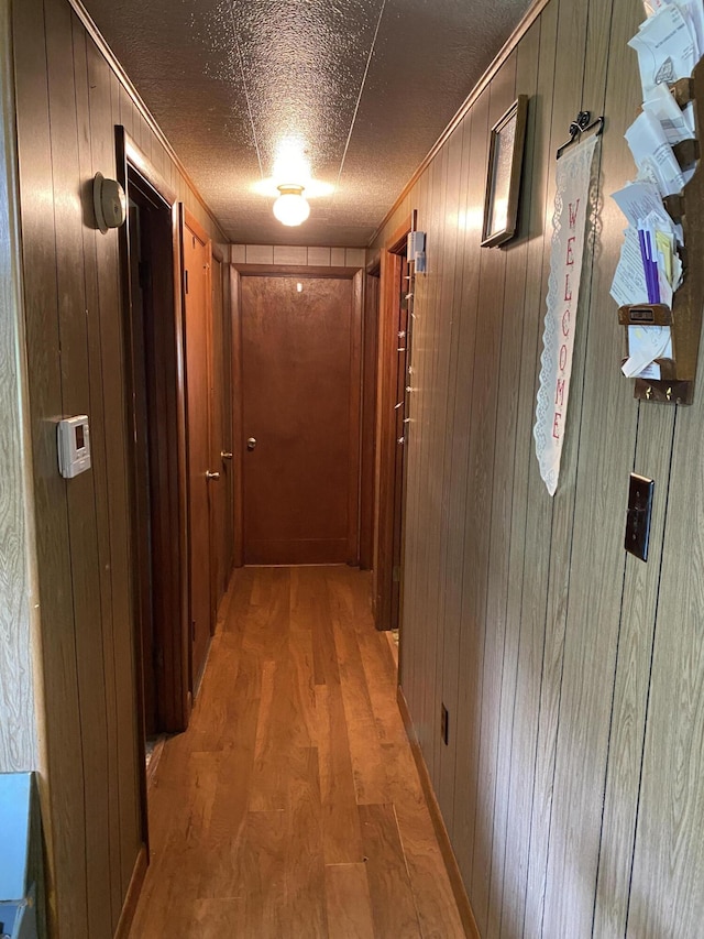 648 Hayes Creek Rd, Strunk, KY 42649 - corridor featuring wood walls, light wood finished floors, and ornamental molding