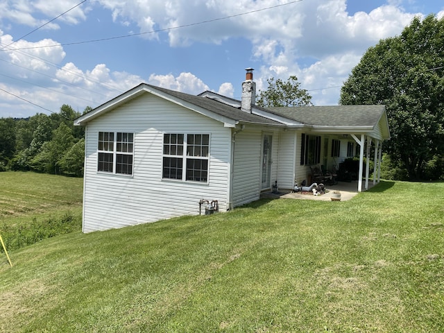 648 Hayes Creek Rd, Strunk, KY 42649 - back of house with a patio area, a yard, a chimney, and a shingled roof