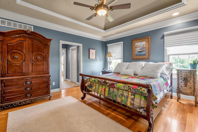 101 Sand Piper Ct, Midway, KY 40347 - bedroom featuring a tray ceiling, ornamental molding, baseboards, light wood-style floors, and a ceiling fan
