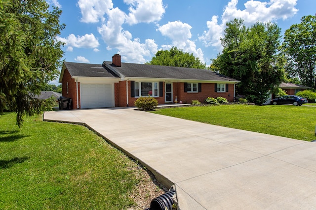 1021 Arapaho Trl, Frankfort, KY 40601 - ranch-style house with an attached garage, driveway, a chimney, a front lawn, and brick siding
