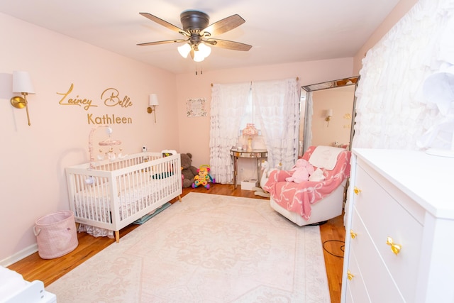 1021 Arapaho Trl, Frankfort, KY 40601 - bedroom featuring wood finished floors, a nursery area, and a ceiling fan