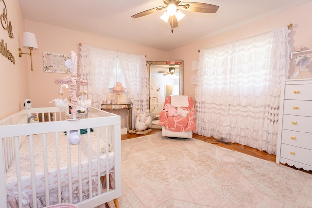 1021 Arapaho Trl, Frankfort, KY 40601 - bedroom featuring a nursery area, wood finished floors, and a ceiling fan