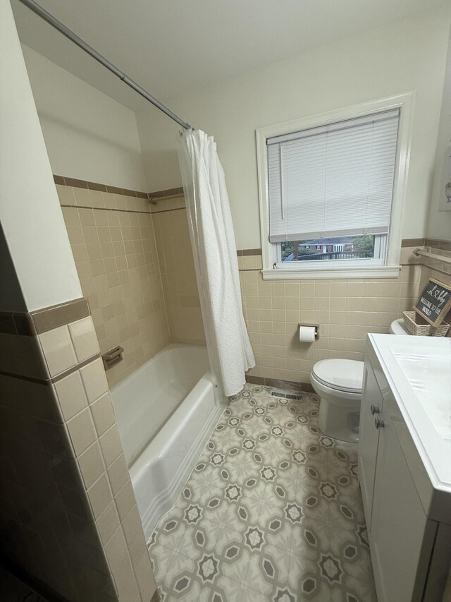 1021 Arapaho Trl, Frankfort, KY 40601 - bathroom featuring tile walls, toilet, vanity, shower / bath combo with shower curtain, and a wainscoted wall