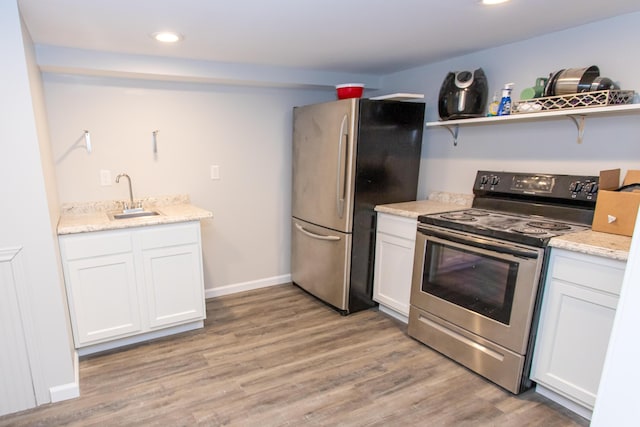 1021 Arapaho Trl, Frankfort, KY 40601 - kitchen with appliances with stainless steel finishes, light wood finished floors, white cabinetry, recessed lighting, and light stone countertops