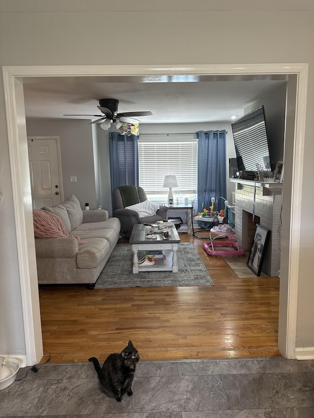 1021 Arapaho Trl, Frankfort, KY 40601 - living room with wood finished floors, a brick fireplace, and ceiling fan