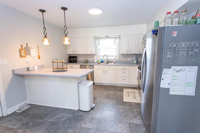 1021 Arapaho Trl, Frankfort, KY 40601 - kitchen featuring appliances with stainless steel finishes, a peninsula, white cabinetry, light countertops, and decorative light fixtures