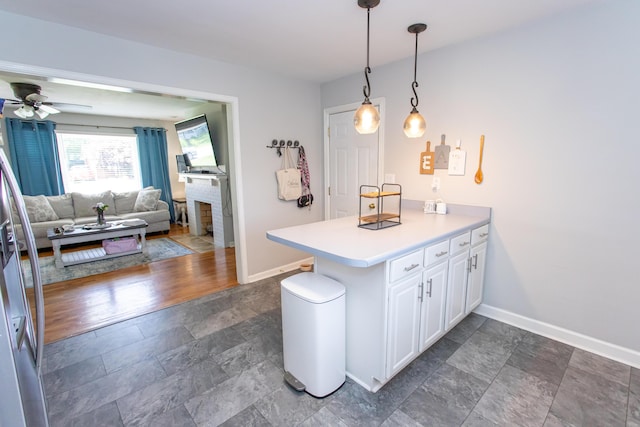 1021 Arapaho Trl, Frankfort, KY 40601 - kitchen featuring a peninsula, white cabinetry, dark stone finish floors, ceiling fan, and light countertops