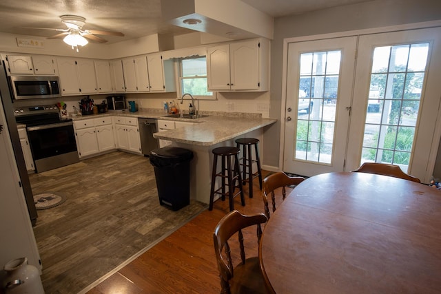 1987 White Rock Rd, Mount Vernon, KY 40456 - kitchen featuring appliances with stainless steel finishes, a peninsula, white cabinetry, and a sink