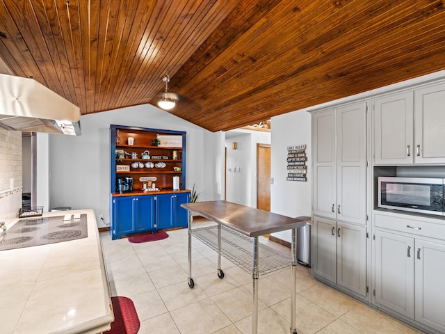 389 Lakeview Dr, Somerset, KY 42503 - kitchen featuring stainless steel microwave, wooden ceiling, under cabinet range hood, vaulted ceiling, and blue cabinetry