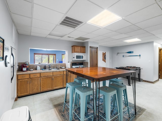 389 Lakeview Dr, Somerset, KY 42503 - kitchen with white appliances, brown cabinetry, a drop ceiling, light countertops, and a sink