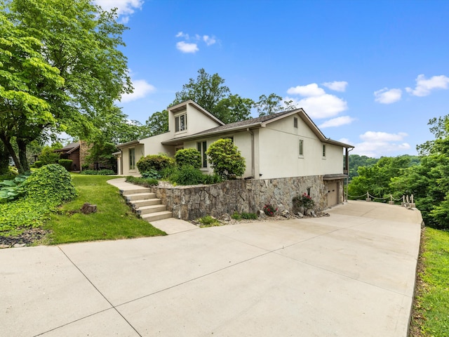 389 Lakeview Dr, Somerset, KY 42503 - view of front of property featuring stucco siding, driveway, a garage, stone siding, and a front yard