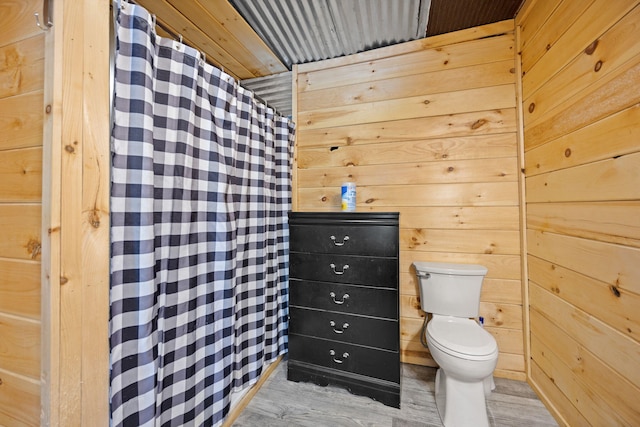 3402 Roundtop Rd, Strunk, KY 42649 - bathroom featuring toilet, wooden walls, wood finished floors, and a shower with curtain