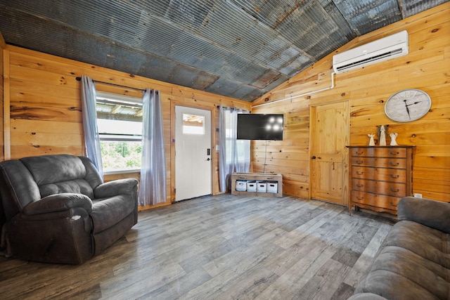 3402 Roundtop Rd, Strunk, KY 42649 - living room with a wall mounted AC, wooden walls, wood finished floors, and high vaulted ceiling