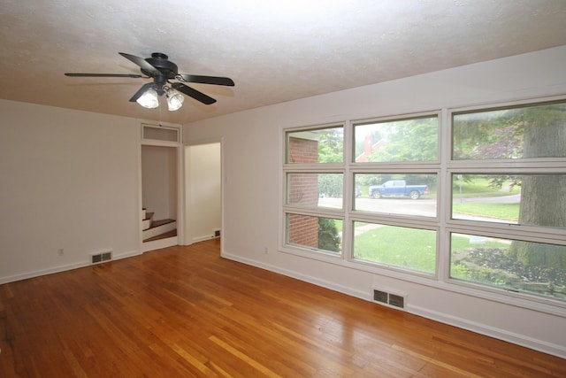 325 Dantzler Ct, Lexington, KY 40503 - unfurnished room featuring baseboards, hardwood / wood-style floors, ceiling fan, and stairway