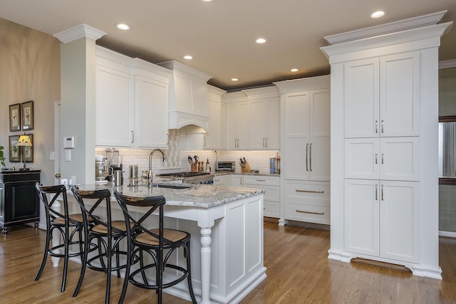 3513 Doral Pl, Lexington, KY 40509 - kitchen featuring a peninsula, white cabinets, a sink, light stone countertops, and dark wood-style floors