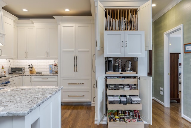 3513 Doral Pl, Lexington, KY 40509 - kitchen with dark wood-style flooring, white cabinetry, light stone countertops, ornamental molding, and decorative backsplash