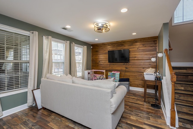 701 Sprucewood Dr, Lexington, KY 40514 - living room with stairs, dark wood finished floors, baseboards, wood walls, and healthy amount of natural light
