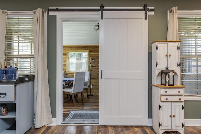 701 Sprucewood Dr, Lexington, KY 40514 - kitchen with wood walls, wood finished floors, a barn door, and white cabinetry
