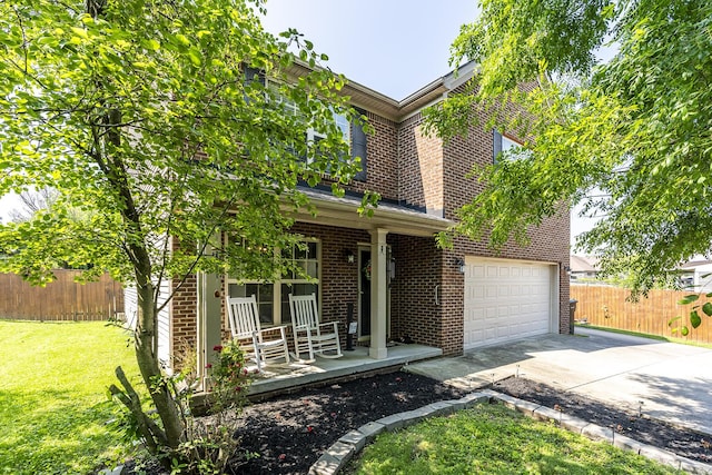 701 Sprucewood Dr, Lexington, KY 40514 - traditional-style home featuring covered porch, brick siding, driveway, and an attached garage