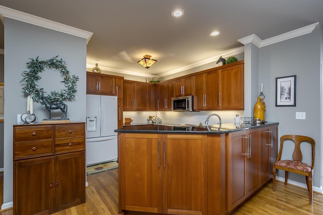 3519 Doral Pl, Lexington, KY 40509 - kitchen featuring stainless steel microwave, white fridge with ice dispenser, light wood-type flooring, dark countertops, and crown molding