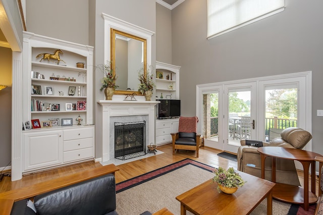 3519 Doral Pl, Lexington, KY 40509 - living area with wood finished floors, a premium fireplace, a towering ceiling, and crown molding