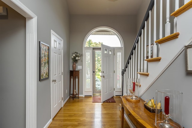 3519 Doral Pl, Lexington, KY 40509 - entryway featuring light wood finished floors, a high ceiling, stairs, and baseboards