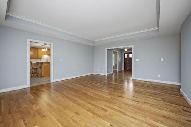 180 Taylors Fork Rd, Richmond, KY 40475 - unfurnished room with a tray ceiling, light wood-style floors, ornamental molding, and baseboards
