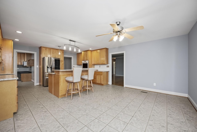 180 Taylors Fork Rd, Richmond, KY 40475 - kitchen with wall oven, stainless steel refrigerator with ice dispenser, recessed lighting, a center island, and a breakfast bar area
