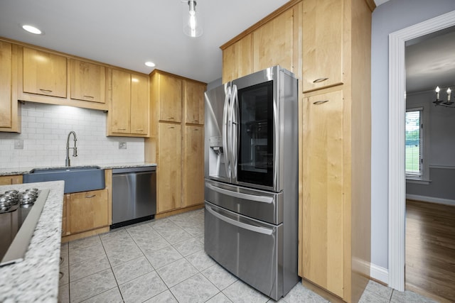 180 Taylors Fork Rd, Richmond, KY 40475 - kitchen with stainless steel appliances, a sink, backsplash, baseboards, and light stone counters