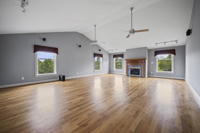 180 Taylors Fork Rd, Richmond, KY 40475 - unfurnished living room with rail lighting, a ceiling fan, a tiled fireplace, wood finished floors, and baseboards
