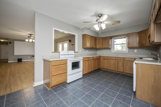 180 Taylors Fork Rd, Richmond, KY 40475 - kitchen featuring white range with electric cooktop, ceiling fan, a sink, light countertops, and brown cabinetry