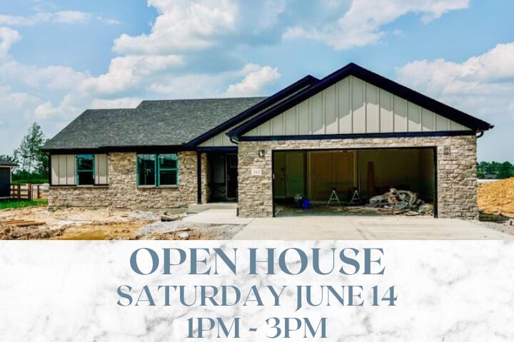 312 Mohegan Trl, Richmond, KY 40475 - view of front of house with a garage, stone siding, board and batten siding, driveway, and roof with shingles