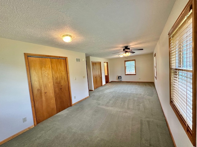 7532 Maysville Rd, Carlisle, KY 40311 - unfurnished bedroom featuring light carpet, baseboards, a ceiling fan, and a textured ceiling