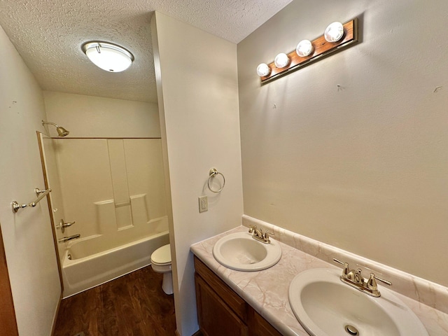 7532 Maysville Rd, Carlisle, KY 40311 - bathroom featuring a textured ceiling, toilet, wood finished floors, washtub / shower combination, and double vanity