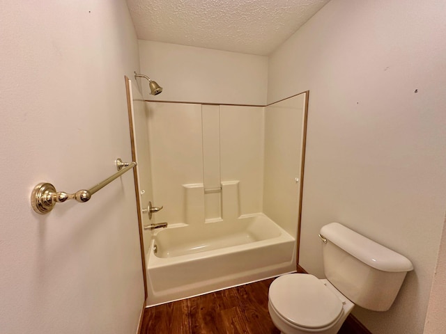 7532 Maysville Rd, Carlisle, KY 40311 - bathroom with a textured ceiling, wood finished floors, toilet, and washtub / shower combination